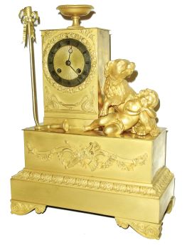 France, Ormolu figural clock showing a dog and child, after playing a form of bilboquette, the clock contained within tower to left, and with paddle and ball catcher showing left side, c1825