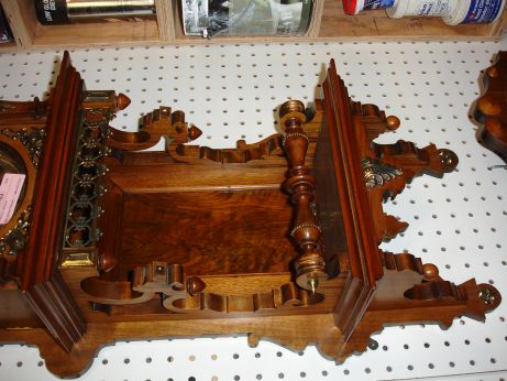 Lenzkirch, Germany, walnut open well or "Freischwinger", with built-in top and with approx 24 pieces of brass decoration, and the fancy cast pendulum depicting a lion