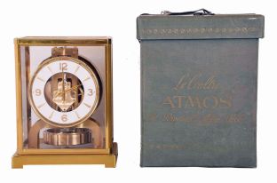 Jaeger LeCoultre, Switzerland, "Atmos" gilt brass and glass perpetual mantel clock, serial number 98063, front door hinges from side, in original green felt carrying box