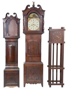Tall Clocks- 4 (Four) and a tall clock case only: (1) English in a wide Yorkshire, short door case, the hood with mask for a 14" dial, 8 day movement with a 13" dial, c1840; (2) Monitor Clockworks mission style time only in oak; (3) S. Hoadley, Plymouth wooden works 30 hour, c1825; (4) Hutchinson, Douglas, Scottish in mahogany veneer case with Escape of Queen Mary" theme on dial including portraits of several famous Scottish poets, c1830; (5) English case only in walnut, c1850