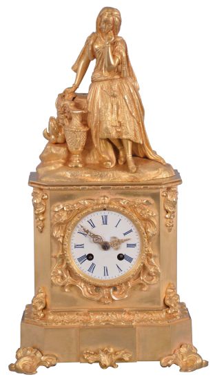 France, a mid 19th century figural mantel clock, gilt bronze case with rococo revival ornament, the top with a young woman with fancy dress and head scarf, resting against a stump, taking a rest from carrying her ewer, Roman numeral white painted dial, gilt Louis XV hands, 8 day pendule de Paris movement by Raingo Freres