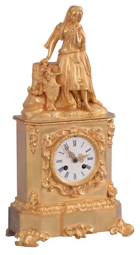 France, a mid 19th century figural mantel clock, gilt bronze case with rococo revival ornament, the top with a young woman with fancy dress and head scarf, resting against a stump, taking a rest from carrying her ewer, Roman numeral white painted dial, gilt Louis XV hands, 8 day pendule de Paris movement by Raingo Freres