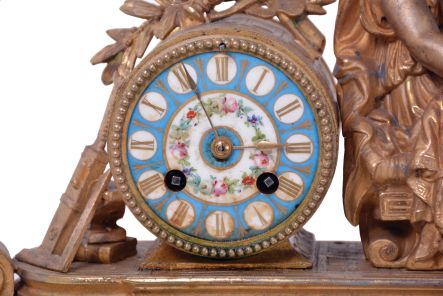 Japy Freres, Paris, France, figural mantel clock, 8 day time and strike, count wheel and bell, spring driven movement with floral themed ceramic dial and insets in a gilt spelter case featuring a seated female figure surrounded by symbols of art and science including a pitcher, gear, paintbrush & pallet, books, steam engine, anvil, spyglass, and square.