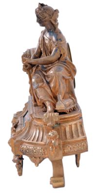 Japy Freres, Paris, France, figural mantel clock, 8 day time and strike, count wheel and bell, spring driven movement with floral themed ceramic dial and insets in a gilt spelter case featuring a seated female figure surrounded by symbols of art and science including a pitcher, gear, paintbrush & pallet, books, steam engine, anvil, spyglass, and square.