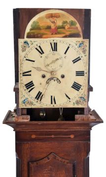 English, 8 day tall clock, time and bell strike, weight driven movement in a mixed veneer/ mahogany inlaid oak case with broken arch top set with brass rosettes and finials, flat reeded pilasters flanking door, painted arch dial with calendar and seconds hand.