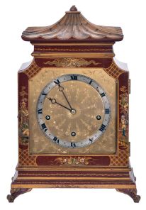 English, 8 day, time and strike spring driven, three train lever movement Westminster chime mantel clock in an Oriental-style gold and red Chinoiserie decorated case.