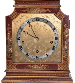 English, 8 day, time and strike spring driven, three train lever movement Westminster chime mantel clock in an Oriental-style gold and red Chinoiserie decorated case.