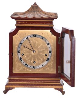English, 8 day, time and strike spring driven, three train lever movement Westminster chime mantel clock in an Oriental-style gold and red Chinoiserie decorated case.
