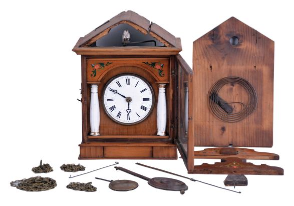 Germany, early Biedermeier cuckoo clock, 30 hour, weight driven movement in a wood case with stenciled floral design, fluted porcelain columns with gold accents and a white porcelain dial. Likely by Theodor Ketterer of Furtwangen, c1860.