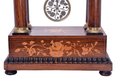 Austria, a mid 19th century portico clock with grand sonnerie striking, the case with rosewood veneers, ripple moldings, and contrasting, foliate marquetry, the columns with cast capitals and bases, Roman numeral silvered dial, blued steel hands, two day brass movement sounding the quarters in passing, and repeating the last hour and quarter on demand, silk suspended pendulum with engine turned rim, and decorative, pierced center