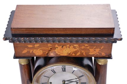 Austria, a mid 19th century portico clock with grand sonnerie striking, the case with rosewood veneers, ripple moldings, and contrasting, foliate marquetry, the columns with cast capitals and bases, Roman numeral silvered dial, blued steel hands, two day brass movement sounding the quarters in passing, and repeating the last hour and quarter on demand, silk suspended pendulum with engine turned rim, and decorative, pierced center