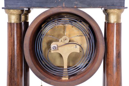 Austria, a mid 19th century portico clock with grand sonnerie striking, the case with rosewood veneers, ripple moldings, and contrasting, foliate marquetry, the columns with cast capitals and bases, Roman numeral silvered dial, blued steel hands, two day brass movement sounding the quarters in passing, and repeating the last hour and quarter on demand, silk suspended pendulum with engine turned rim, and decorative, pierced center