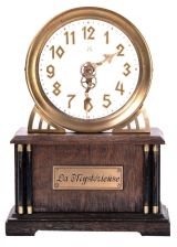 German, Hamburg - American Clock Co., "La Mysterieuse" desk or table clock, rectangular oak base supporting the Arabic numeral transparent dial with brass bezel, movement contained in the base, and driving a second invisible disc to which the motion work is attached, thus driving the hands