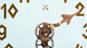 German, Hamburg - American Clock Co., "La Mysterieuse" desk or table clock, rectangular oak base supporting the Arabic numeral transparent dial with brass bezel, movement contained in the base, and driving a second invisible disc to which the motion work is attached, thus driving the hands