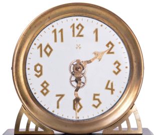 German, Hamburg - American Clock Co., "La Mysterieuse" desk or table clock, rectangular oak base supporting the Arabic numeral transparent dial with brass bezel, movement contained in the base, and driving a second invisible disc to which the motion work is attached, thus driving the hands