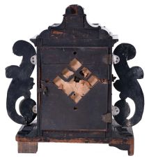 Europe, 18th century, bracket or shelf clock with cow tail pendulum, ebonized wooden case with applied moldings and laden with leaf and scroll, repousse silver ornaments, and case sides with applied scroll ornaments Roman numeral white enamel dial with raised chapter and concave center, fancy pierced and engraved brass hands, brass time and strike movement probably of two day duration, with verge escapement, and engraved, star shaped pendulum swinging in front of the dial