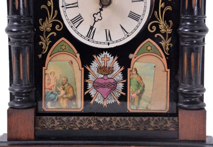 Black Forest: Hans Konrad, Brux Czech Republic, Biedermeier style wall clock, 30 hour, time and gong strike, weight-driven movement with wood plates and brass wheels within a pine case with reverse painted glass front. The overall form of the case is typical of Black Forest Biedermeier wall clocks and the mechanism is essentially the same as most cuckoo clocks of this vintage. The elaborate case ornamentation features Catholic themes such as the cross, the Sacred Heart, and two small prints depicting Jesus.