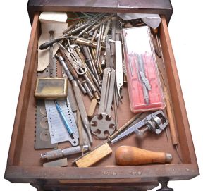 Assorted clock and watch tools in six drawer wood cabinet. Tools include a small bench vise, alcohol torches, truing calipers, pliers, tongs, files, hammers, screw plates, pin vises, screwdrivers, tweezers, 10 WW lathe collets, and other useful hand tools.