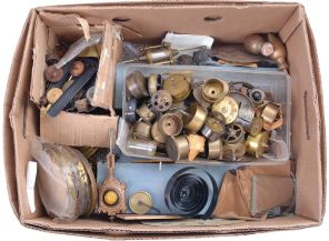 Clock parts including partial and complete cases, glass domes, finials, banjo brackets, chime rods, spring barrels, hands, pendulum bobs, dials, and other useful items. One of the partial cases is from a Welch, Spring & Co. "Patti" model. 8 (Eight) boxes total.