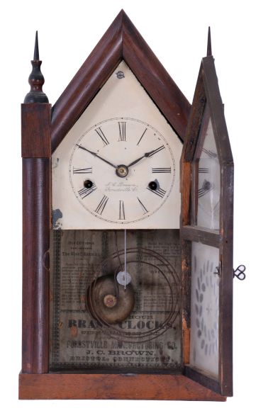 J. C. Brown, Forestville Manufacturing Co., Bristol, Conn., miniature steeple shelf clock with a 30 hour spring driven time and strike movement in a mahogany veneered case. Signed 30-hr time and strike movement.
