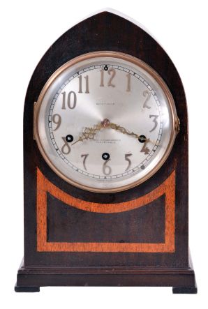 Seth Thomas Clock Co., Thomaston, Conn., "Chime No. 95" shelf clock with an eight day spring driven time and Westminster strike movement (124A) chiming on rods, in a two tone mahogany veneered case with a silvered dial and raised bronze numerals.