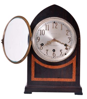 Seth Thomas Clock Co., Thomaston, Conn., "Chime No. 95" shelf clock with an eight day spring driven time and Westminster strike movement (124A) chiming on rods, in a two tone mahogany veneered case with a silvered dial and raised bronze numerals.