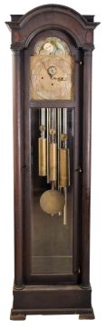 Colonial Manufacturing Co., Zeeland, Michigan, tall clock, quality German-made 8 day, time, strike three brass weight driven movement, with Westminster chime on tubes, in an inlaid mahogany case with full length full columns flanking a full length door with lower beveled glass, brass dial with moon phase and engraved spandrels.