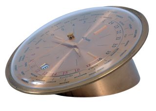 Le Coultre & Co., Switzerland, model 482 "World Time" desk clock, gilt case with convex glass, gilt dial with 34 cities around perimeter, and also with date display at 6:00, 8 day timepiece movement