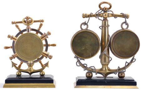 Clocks- 2 (Two): Both with nautical theme, the first signed "Lawson & Son Paris", brass trimmed, black slate base supporting a brass anchor encircled by rope, and with 8 day timepiece and barometer, both with white enamel dials, and rectangular plaque engraved "Vigilant", the other also with brass trimmed, black slate base supporting a brass anchor and 8 day timepiece with white enamel dial, the bezel with ships wheel surround, dimensions of larger piece listed
