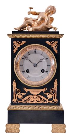 France, a small gilt and patinated bronze mantel clock in the Empire style, case with green patination and gilt mounts, surmounted by a reclining putto, Roman numeral, engine turned, silvered dial, blued steel Breguet style hands, 8 day, time and strike, pendule de Paris movement, signed Marti