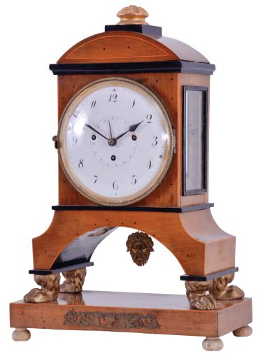 Vienna, Austria, Biedermeier mantel clock with grand sonnerie striking, fruitwood veneer case with ebonized trim and moldings, contrasting line inlay and brass mounts, resting on gilt paw feet, and supported on an oblong base with turned feet, Arabic numeral white enamel dial with date display, 60 hour, three train movement with silk thread suspension and mask pendulum