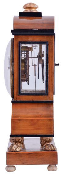 Vienna, Austria, Biedermeier mantel clock with grand sonnerie striking, fruitwood veneer case with ebonized trim and moldings, contrasting line inlay and brass mounts, resting on gilt paw feet, and supported on an oblong base with turned feet, Arabic numeral white enamel dial with date display, 60 hour, three train movement with silk thread suspension and mask pendulum