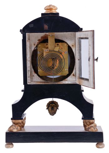 Vienna, Austria, Biedermeier mantel clock with grand sonnerie striking, fruitwood veneer case with ebonized trim and moldings, contrasting line inlay and brass mounts, resting on gilt paw feet, and supported on an oblong base with turned feet, Arabic numeral white enamel dial with date display, 60 hour, three train movement with silk thread suspension and mask pendulum