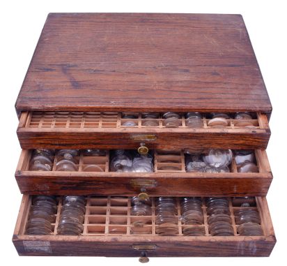 Watch crystals, three drawer cabinet with hundreds of glass crystals, from wrist watch to large pocket watch size