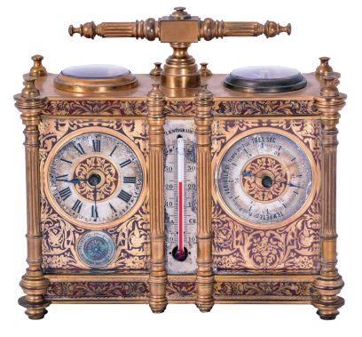 Victorian desk compendium of double carriage clock form, gilt brass case with turned feet, finials, and fluted columns, eight beveled glasses, and engraved panels with red enamel infill, the left side containing the clock, Roman numeral silvered dial, blued steel hands, 8 day time and alarm movement with lever platform, the right side with barometer and compass, both with silvered dials and blued steel indicators, case front also mounted with centigrade thermometer, case top with carrying handle