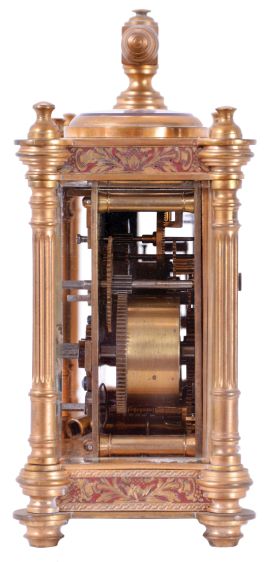 Victorian desk compendium of double carriage clock form, gilt brass case with turned feet, finials, and fluted columns, eight beveled glasses, and engraved panels with red enamel infill, the left side containing the clock, Roman numeral silvered dial, blued steel hands, 8 day time and alarm movement with lever platform, the right side with barometer and compass, both with silvered dials and blued steel indicators, case front also mounted with centigrade thermometer, case top with carrying handle