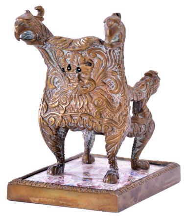 Viennese armchair form desk clock, cast brass case set with polychrome enamel panels, the casting with foliate ornament and griffin heads at upper back, and arms with the heads of other mythical beasts, enamel panels done in typical 19th century Viennese style, with figures, and classical ornament, the chair back set with a 30 hour key wound timepiece
