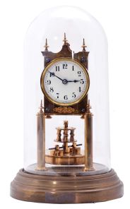 German 400-Day or Anniversary clock: (Retailer =Kuehl Clock Company, Chicago), time only spring driven movement torsion pendulum movement by Gustav Becker of Freiburg, Germany with disc pendulum in polished brass case under glass dome, c1910.