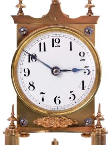 German 400-Day or Anniversary clock: (Retailer =Kuehl Clock Company, Chicago), time only spring driven movement torsion pendulum movement by Gustav Becker of Freiburg, Germany with disc pendulum in polished brass case under glass dome, c1910.