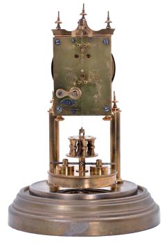 German 400-Day or Anniversary clock: (Retailer =Kuehl Clock Company, Chicago), time only spring driven movement torsion pendulum movement by Gustav Becker of Freiburg, Germany with disc pendulum in polished brass case under glass dome, c1910.