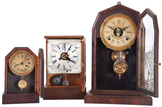 Clocks- 3 (Three): (1) E. N. Welch Mfg. Co., Forestville, Conn., "Empress V.P." shelf clock with a spring driven, 8 day, time and strike movement in a rosewood veneered case, c1880; (2) Unidentified American Cottage clock, probably Waterbury, with a spring driven 30 hour time and alarm movement in a rosewood veneered case, c1870; (3) The Terry Clock Co., Waterbury, Conn., Cottage clock with a spring driven 30 hour timepiece movement in a mahogany veneered case, c1870.