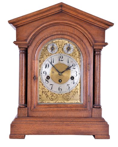 Junghans, Germany, 8 day spring driven movement, three train Westminster chime bracket clock with A13 movement in an architectural style mahogany case. The clock chimes the quarters on 4 rods. The hour is struck on a fifth deeper toned rod, c1900.
