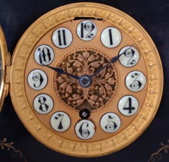 Boston Clock Co., Boston Mass., black mantel clock, 8 day, time and strike with single arbor tandem wind in a black slate case with green marble accents and fancy dial with raised cartouche numerals, c1895.