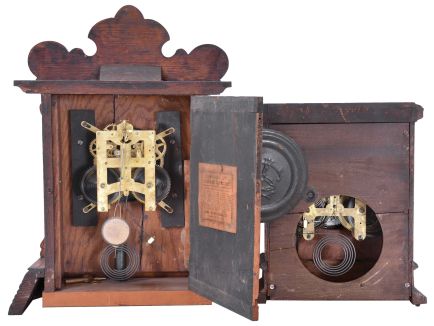 Clocks- 4 (Four) American Wood Case: (1) Seth Thomas Clock Co., Thomaston, Conn., 8 day, time and strike, spring driven movement cabinet clock in oak case with applied metal griffin ornaments, c1892; (2) New Haven Clock Co., New Haven, Conn., "Congressional Line", 8 day, time and strike, spring driven movement cabinet clock in oak case, c1895; (3) Waterbury Clock Co., Waterbury, Conn., "Festus", 8 day, time and strike, spring driven movement gingerbread clock in oak case, c1906; (4) Forestville Manufacturing Company, Bristol, Conn., 8 day, time and strike, weight-driven OOG clock in rosewood veneer case, c1850.