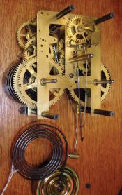 Waterbury Clock Co., Waterbury, Conn., "Kendall" wall hanging clock with a spring driven, 8 day time and half hour strike (cathedral gong) movement in an oak case.