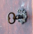 New York Standard Watch Co., Jersey City, New Jersey, electric hanging regulator, walnut case with molded door and base, Roman numeral painted dial with brass bezel, in line movement with Hipp toggle, pendulum with ebonized wooden rod and heavy brass clad ball
