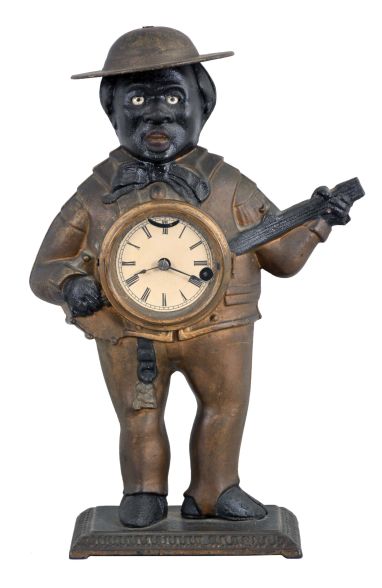 Bradley and Hubbard, Meriden, Conn., "Sambo" blinking eye clock with a spring driven balance wheel timepiece movement (unsigned) in a cast iron case.