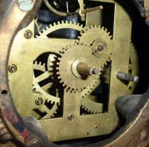 Bradley and Hubbard, Meriden, Conn., "Sambo" blinking eye clock with a spring driven balance wheel timepiece movement (unsigned) in a cast iron case.