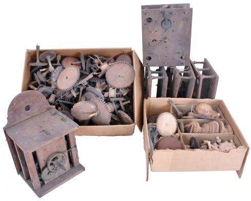 Wooden Works Movement Parts: One Connecticut 30 hour weight-driven wooden works shelf clock movement along with three pairs of oak plates and a large supply of wooden wheels, wooden pinions, and related wooden works movement parts. The lot includes a signed Black Forest wood plate movement with brass wheels.