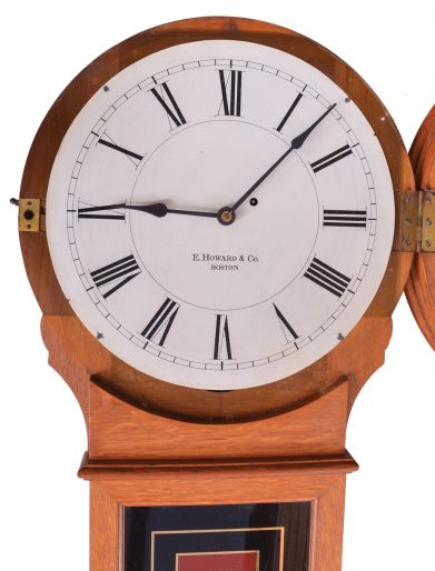 E. Howard & Co., Boston, Mass., "No. 70-16 Regulator", wall clock, oak case with turned wooden bezel and reverse painted tablet, Roman numeral painted dial, blued steel hands, and 8 day, time only, weight driven movement